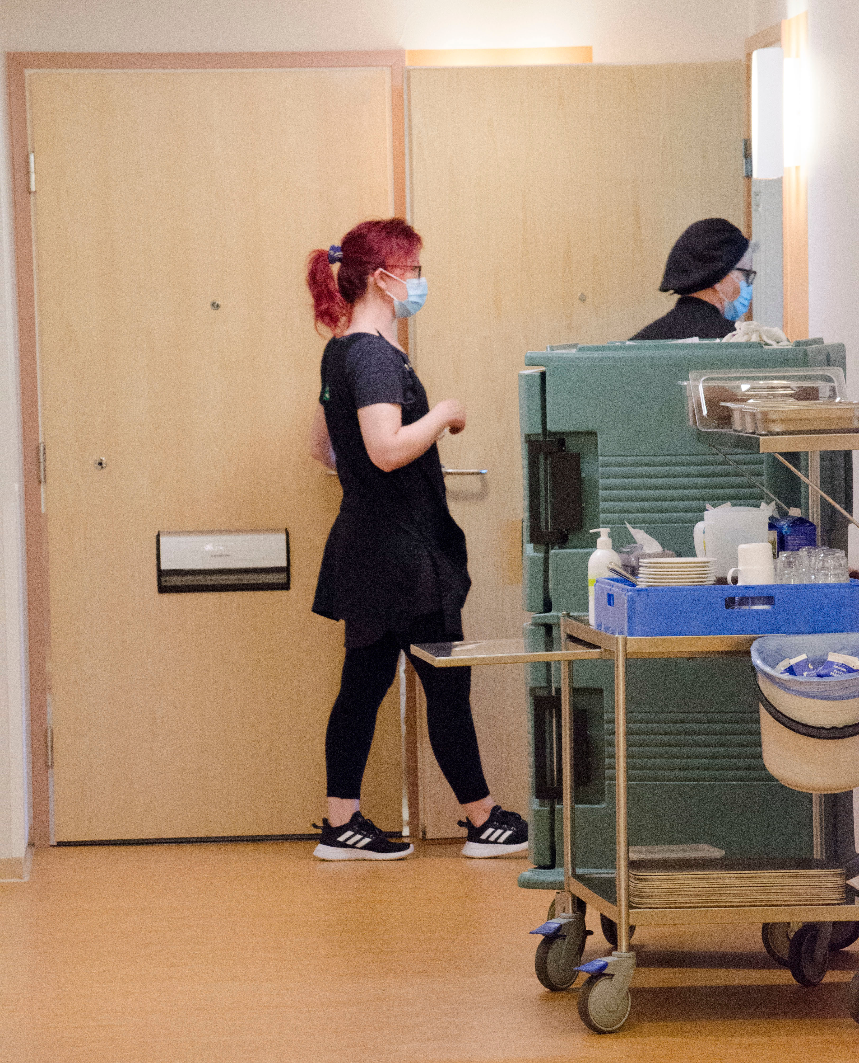 hoitajat vievät ruokaa asukkaalle